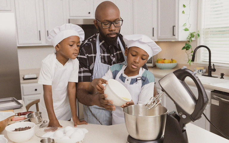Father baking with sons